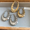 Textured Open Oval Huggie Earrings with Polished Metal Tone Details view 1