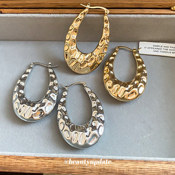 Textured Open Oval Huggie Earrings with Polished Metal Tone Details