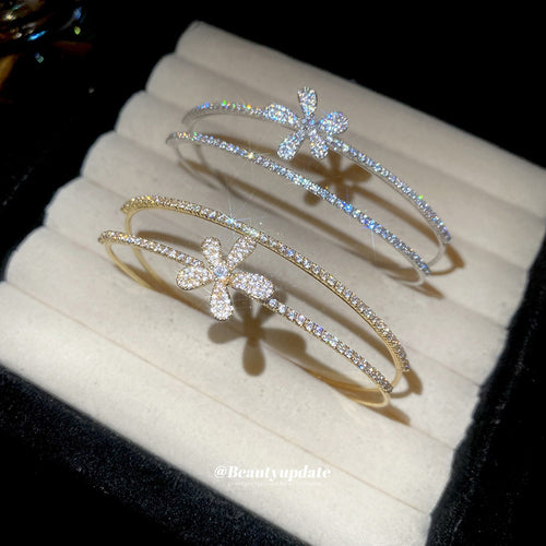 double-row crystal flower open cuff in gold-tone or silver-tone finishes shown worn in a styled second view