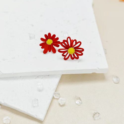 Red matte daisy flower stud earrings with yellow centers on white stone