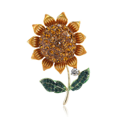 Front view of a warm yellow sunflower with a crystal center and green leaves