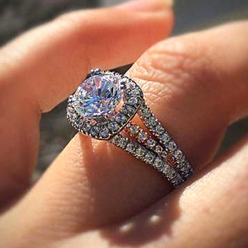 Front view showing a square center, halo, and split stone-set band