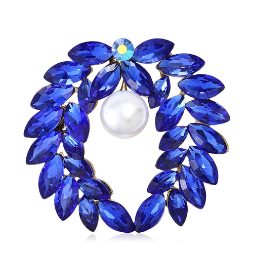 Front view of the laurel pearl wreath brooch showing a circular laurel wreath of marquise stones with a white faux pearl
