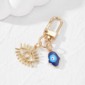 Gold Tone Open Lash Eye and Blue Evil Eye Clip Keychains view 4