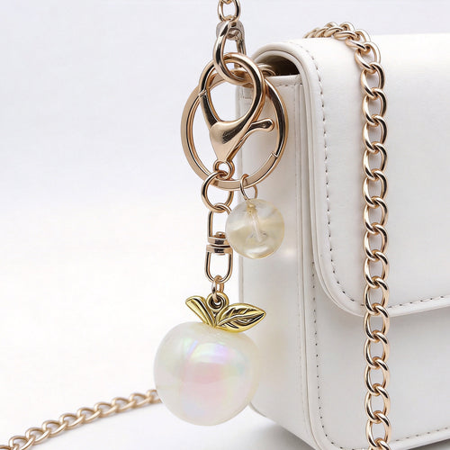 Front product photo of six-color iridescent apple double ring keychain showing the pictured design arrangement