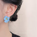 Pale Blue Five Petal Flower And Yellow Center Stud Earrings view 2