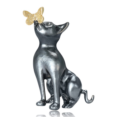 Black Enamel Sitting Cat Brooch with Small Gold Butterfly front view on a light background