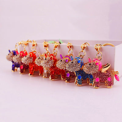 A row of multicolored stone-covered unicorn charms hanging from gold-tone clasps.