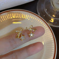 Pair of Metal Tone Star and Bow Drop Earrings with Crystal Accents view 6