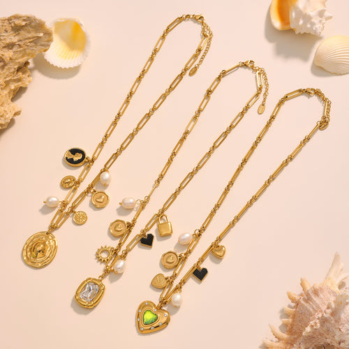 Three gold paperclip multi-charm necklaces laid with shells
