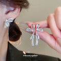 Crystal Bow Tassel Earrings with Asymmetric Silver Tone Drops view 1