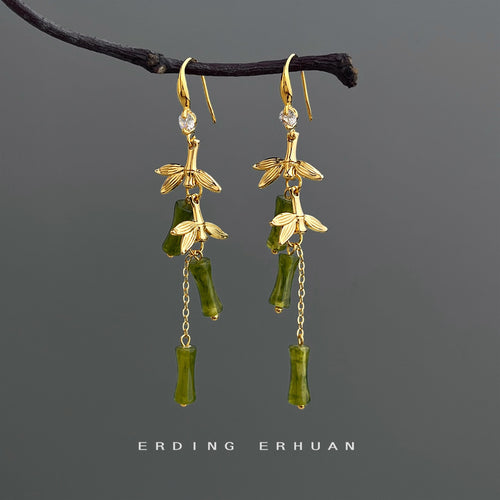 Gold-tone green-bamboo-branch long-hook earrings in the first product display.