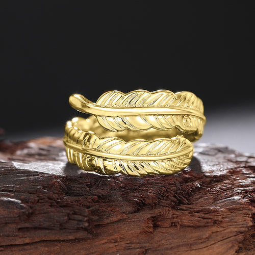 Angled detail view of silver tone triple feather leaf open ring with dark details