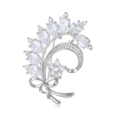 A curling bow and leafy bouquet set with clear crystals shown on a white background