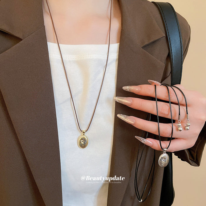 Textured Oval Pendant Necklace On Brown Cord Jewelry Design