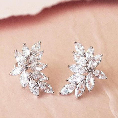 White gold marquise leaf cluster stud earrings pair on fabric