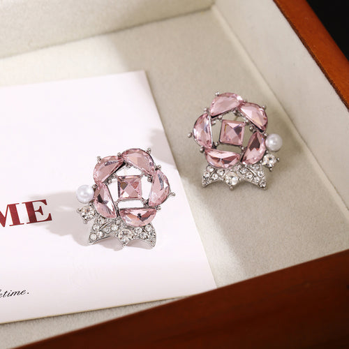 Pink crystal rose flower studs with pearl accents in jewelry tray