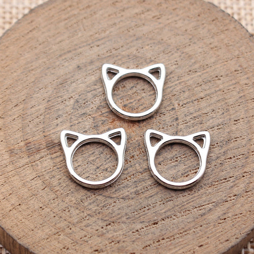 Angled view of open cat-head frame charms in the pictured finish
