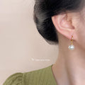 Gold Huggie Hoop Earrings White Glass Pearl Drop Charm view 2