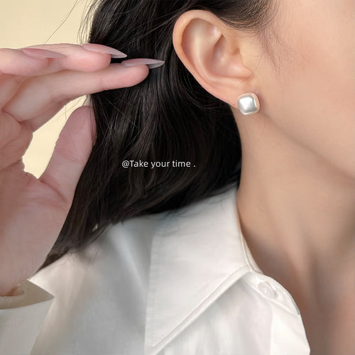 White square cushion pearl stud worn on ear side profile