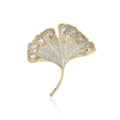 Front view of a gold-tone ginkgo leaf filled with clear or green stones