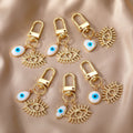 Gold Tone White Shell Evil Eye Charm Clip Keychains in Six Shapes view 1