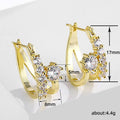 Gold Tone Crossed Bar Crystal Hoop Earrings with Polished Metal Finish view 4