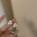 Floral Pearl Stud Earrings in White and Gold with Polished Metal Details view 3