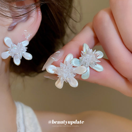 displayed pair of pastel crystal flower stud earrings