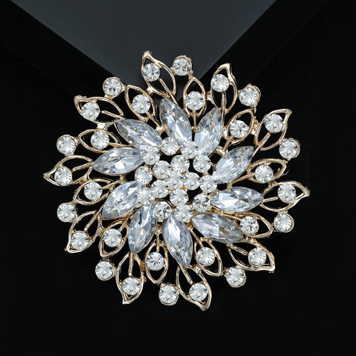 Gold-tone openwork flower brooch on black velvet surface