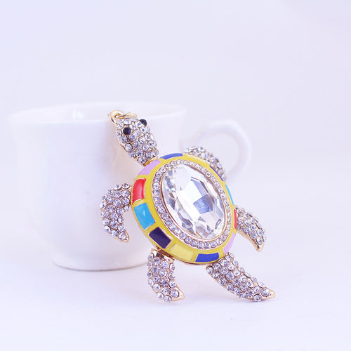 Angled front view showing the faceted clear center and rhinestone-covered flippers.
