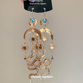 Gold Tone Sun Moon and Snake Dangle Earrings With Polished Metal Details view 2