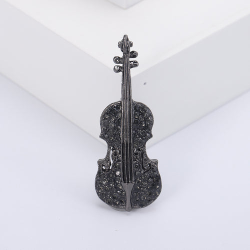 Close-up product view showing the colors and surface details of the crystal violin brooch