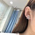 Silver Tone Four Petal Floral Stud Earrings with Clear Stones view 4