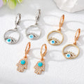 Gold Tone Crystal Hamsa and Evil Eye Huggie Drop Earrings view 1