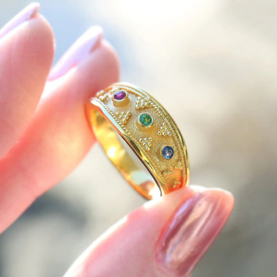 Front product view of gold tone wide band ring with multicolor round stones