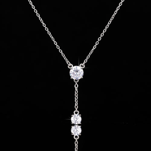 Y lariat double round clear pendant front on pure black background