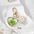 Gold Tone Daisy and Pressed Flower Heart Snap-Hook Keychains in Ten Options view 4
