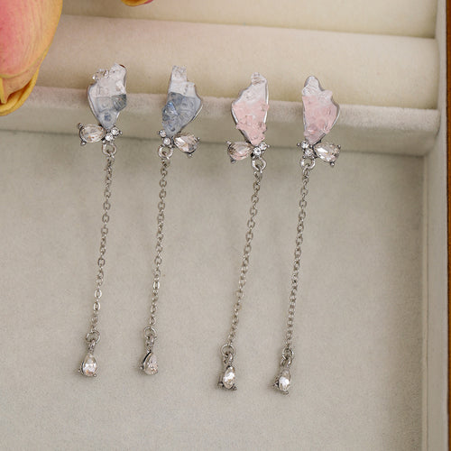 Pink and blue butterfly chain drop earrings displayed in jewelry tray