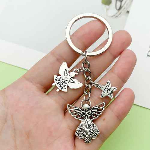 Image 2 showing a hand holding two key chains with charms.