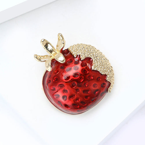 Red Pomegranate Brooch displayed in a styled setting