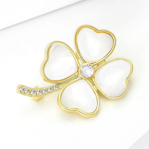 Clover brooch angled on white surface showing crystal stem