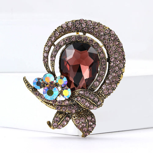 Angled view showing the round jeweled brooch brooch surface