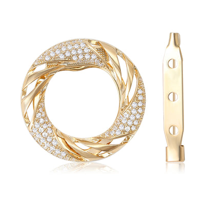 Gold Tone Twisted Circle brooch With Crystal Accent shown in front view on a light background