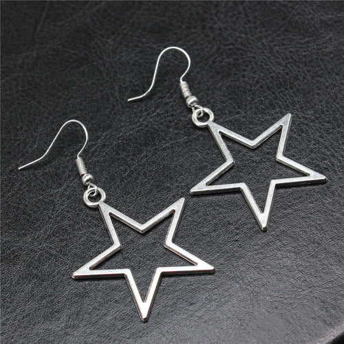 Alternate angle of open star drop earrings showing open star drops suspended from fishhook ear wires