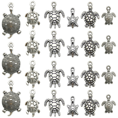 Antique silver turtle charms arranged on a light background