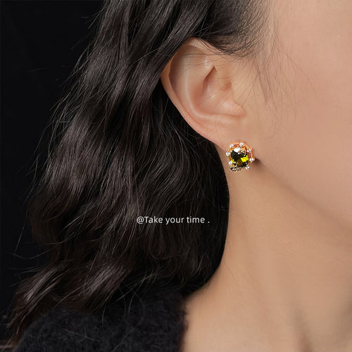 Gold olive CZ butterfly stud worn on ear side profile
