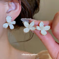 White Floral Shell Look Stud Earrings in Two Sizes view 2