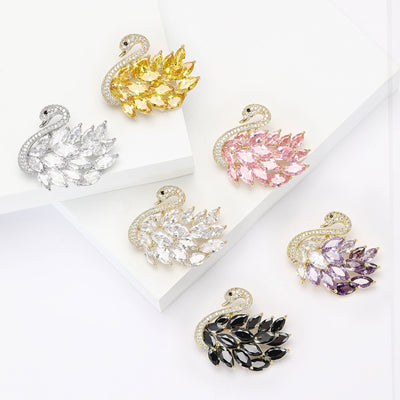 Six swan brooches in yellow silver pink clear purple black