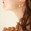 Flat Oval Huggie Hoop Earrings Gold And Steel Tone Metal view 1
